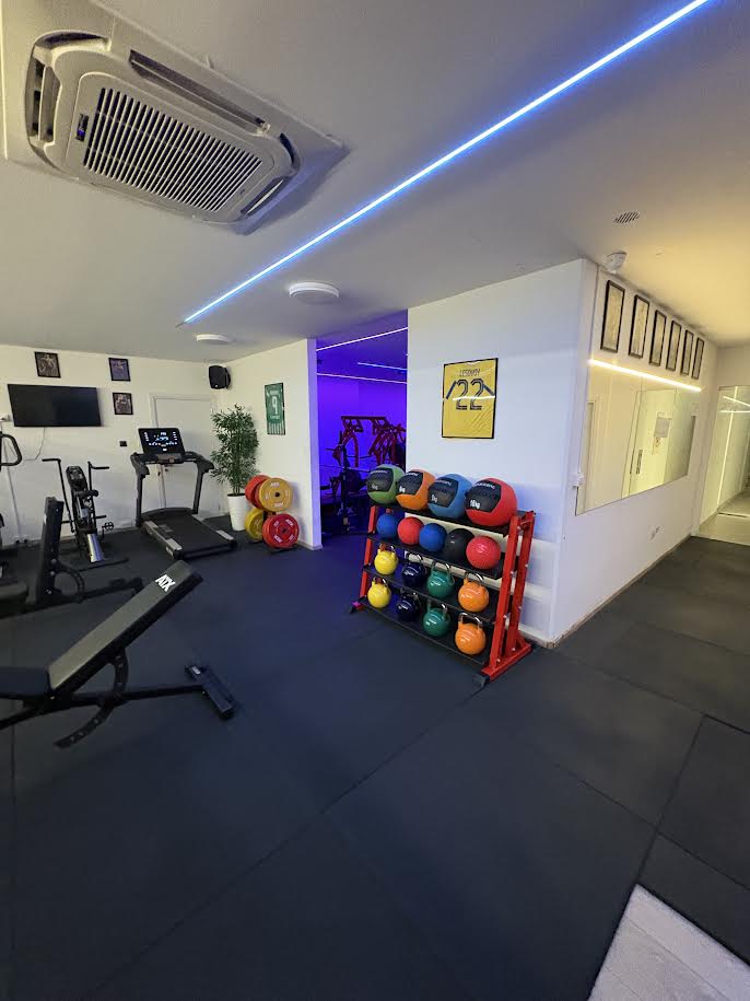 Training floor with treadmills, weights and medicine balls